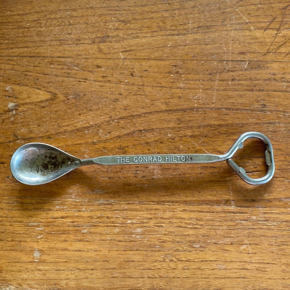 Vintage “The Conrad Hilton” silver tone Vaughan bar spoon with bottle opener